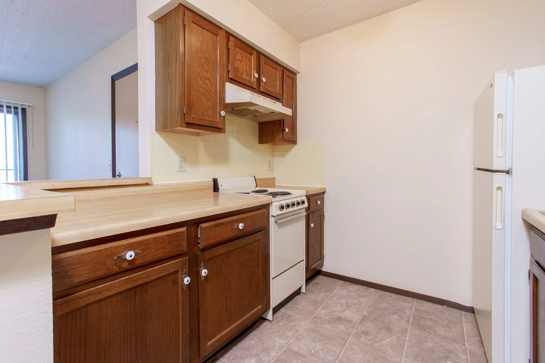 Original one bedroom kitchen with oak cabinetry and laminate counters.