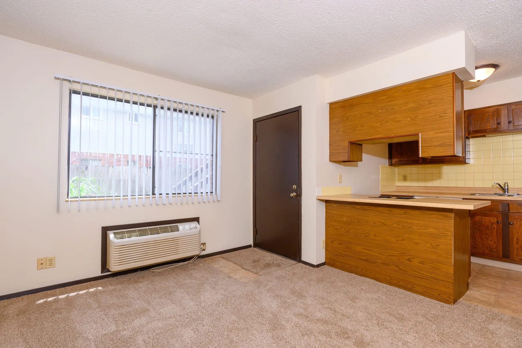 A studio at Stoneybrook in its original condition, with carpet and the 1978 kitchen.