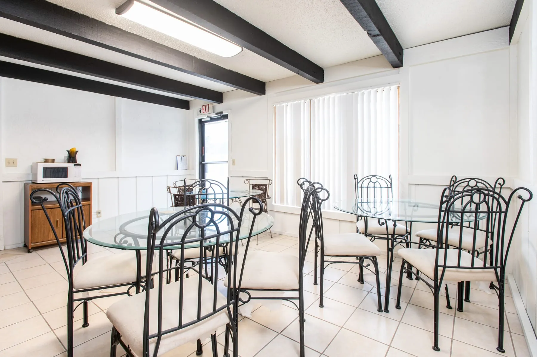 Glass-top dining tables in the Stoneybrook clubhouse.
