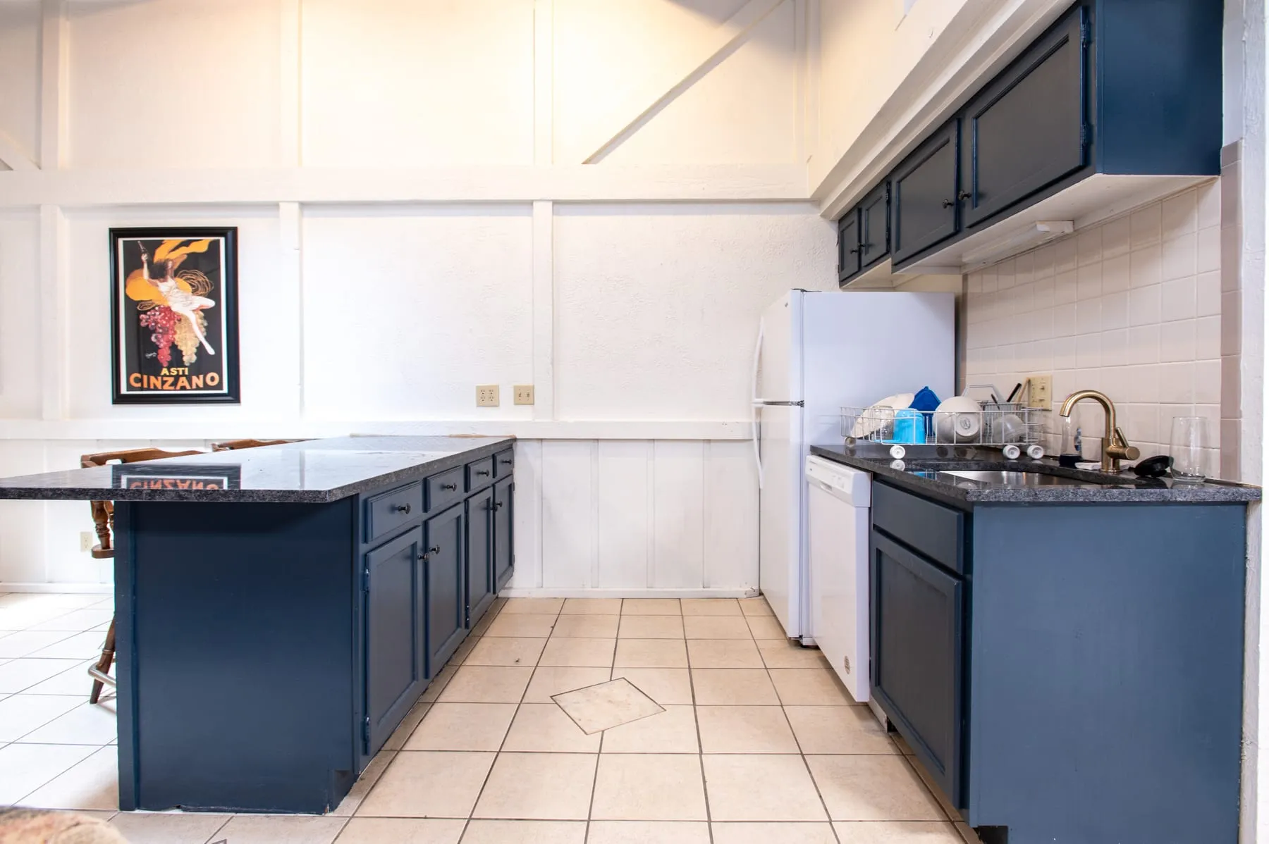 Clubhouse kitchen counter run with refrigerator and sink.