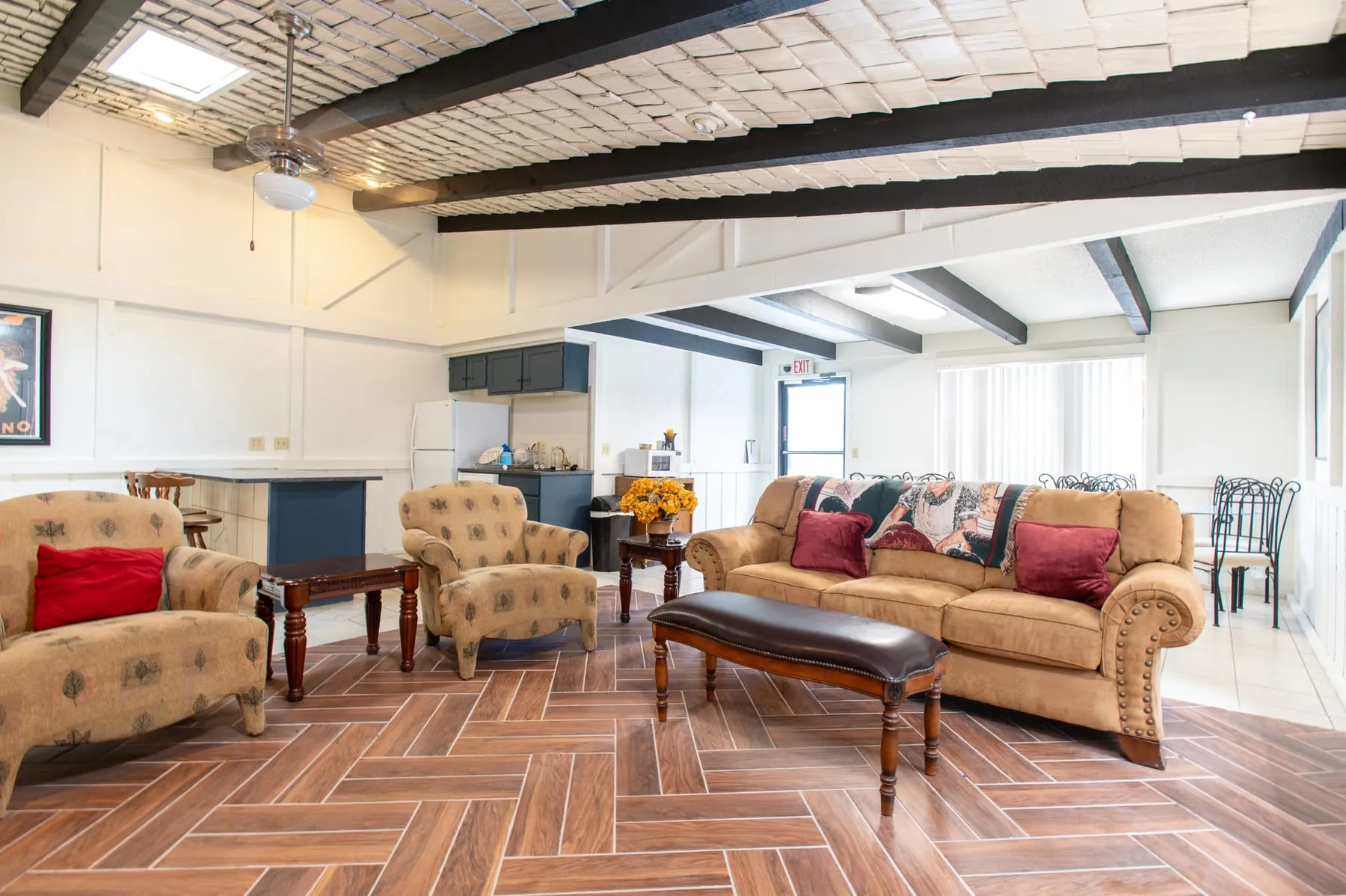 Seating area in the Stoneybrook clubhouse beneath original exposed beams.