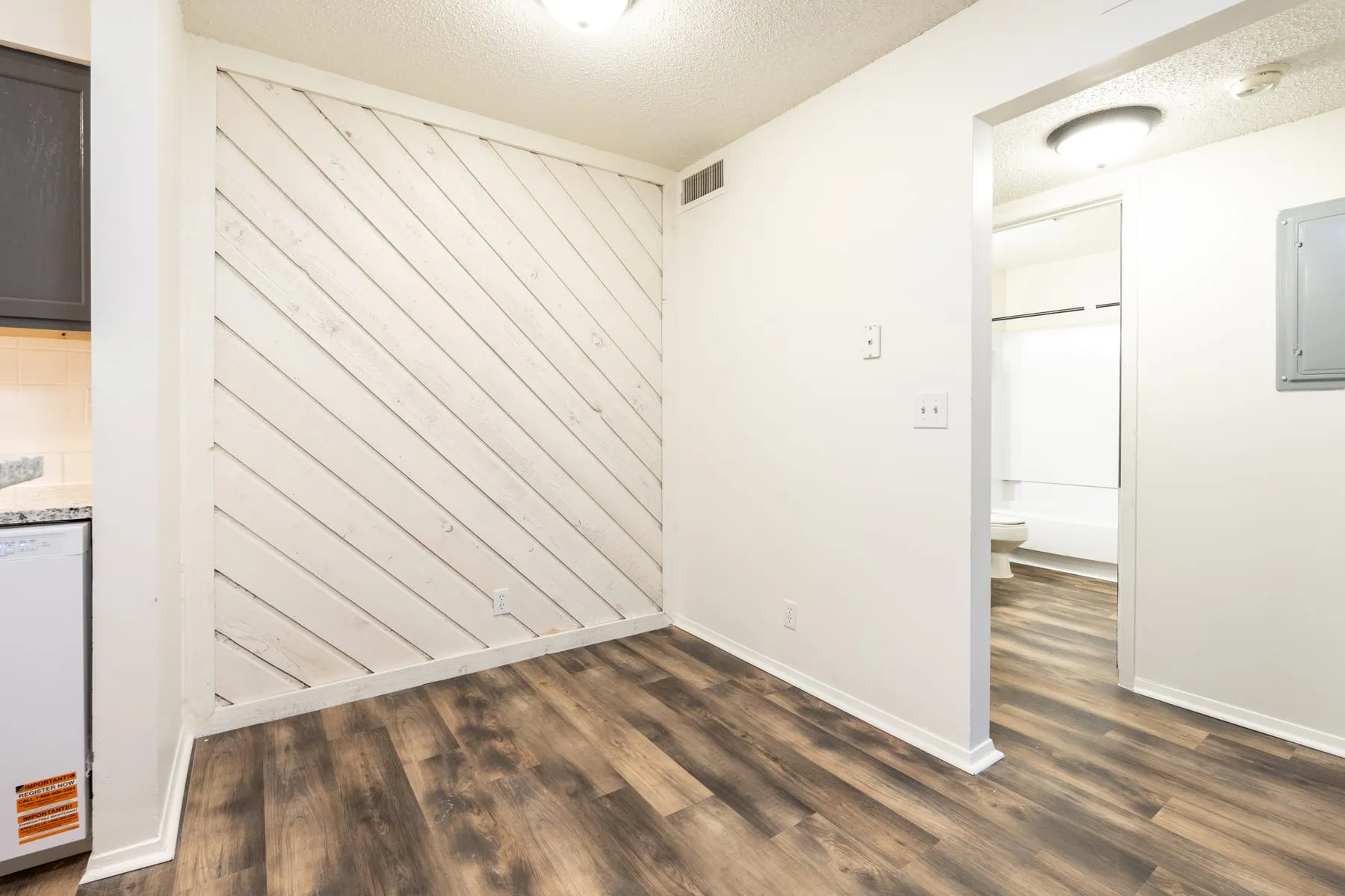 White diagonal plank accent wall in a renovated one bedroom home.