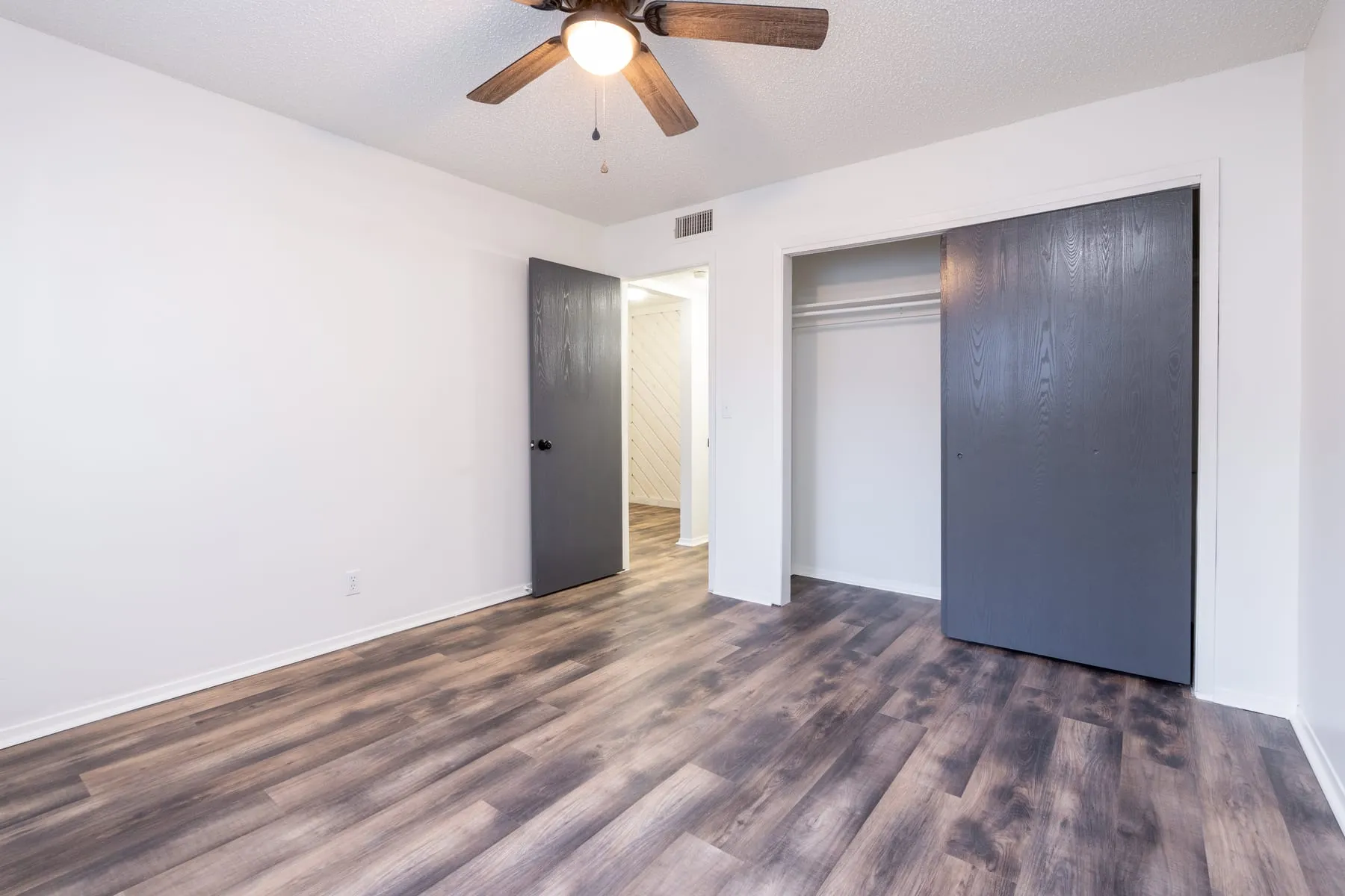 One bedroom sleeping area with a closet and adjoining hallway.