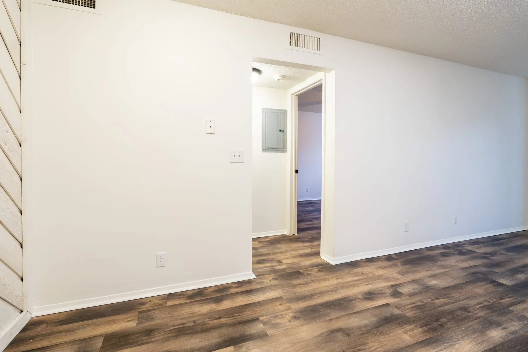 Hallway in a renovated one bedroom home leading toward the bedroom.