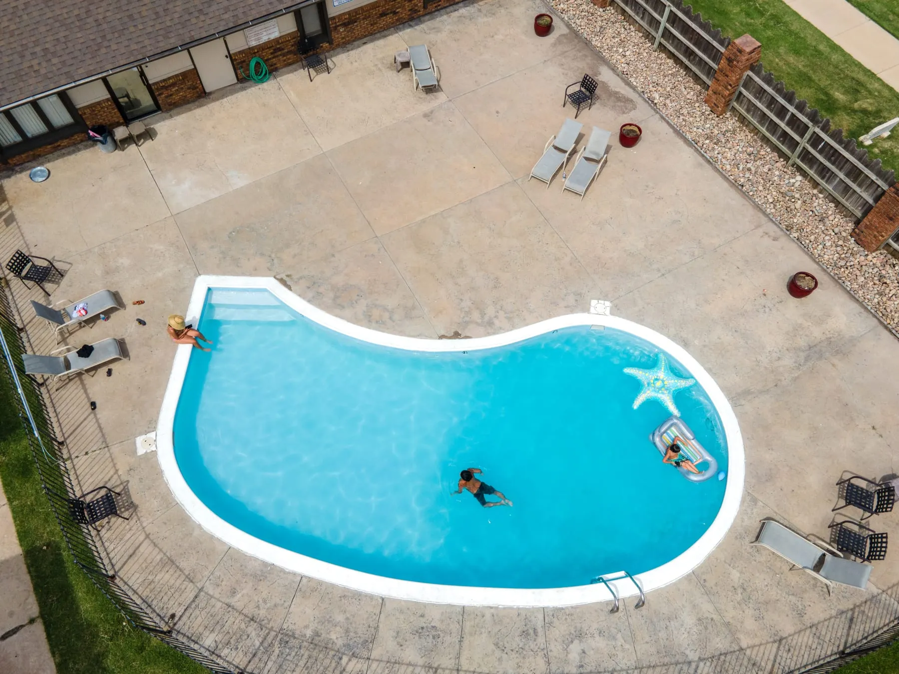 Aerial view of the Stoneybrook pool with a swimmer and surrounding sun deck.