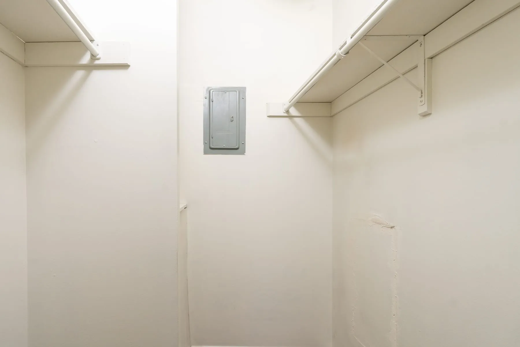 Studio storage closet with fitted wire shelving.