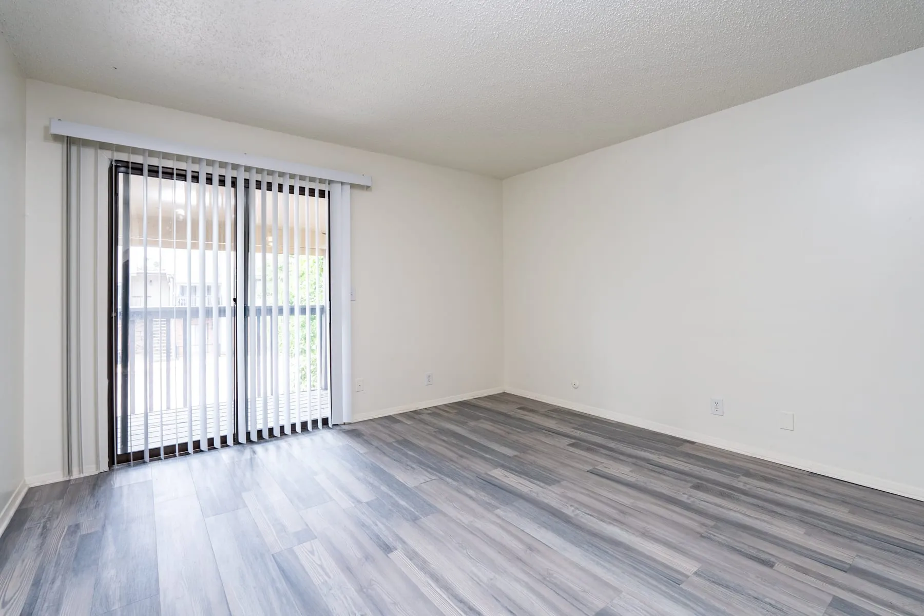 Two bedroom living area with a sliding glass door to the private balcony.